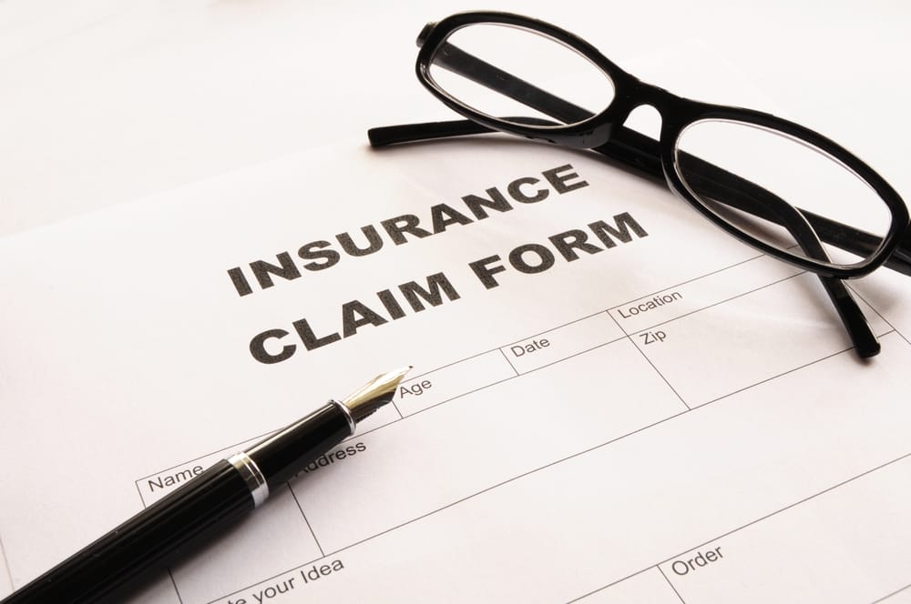 An insurance claim form with a pen.